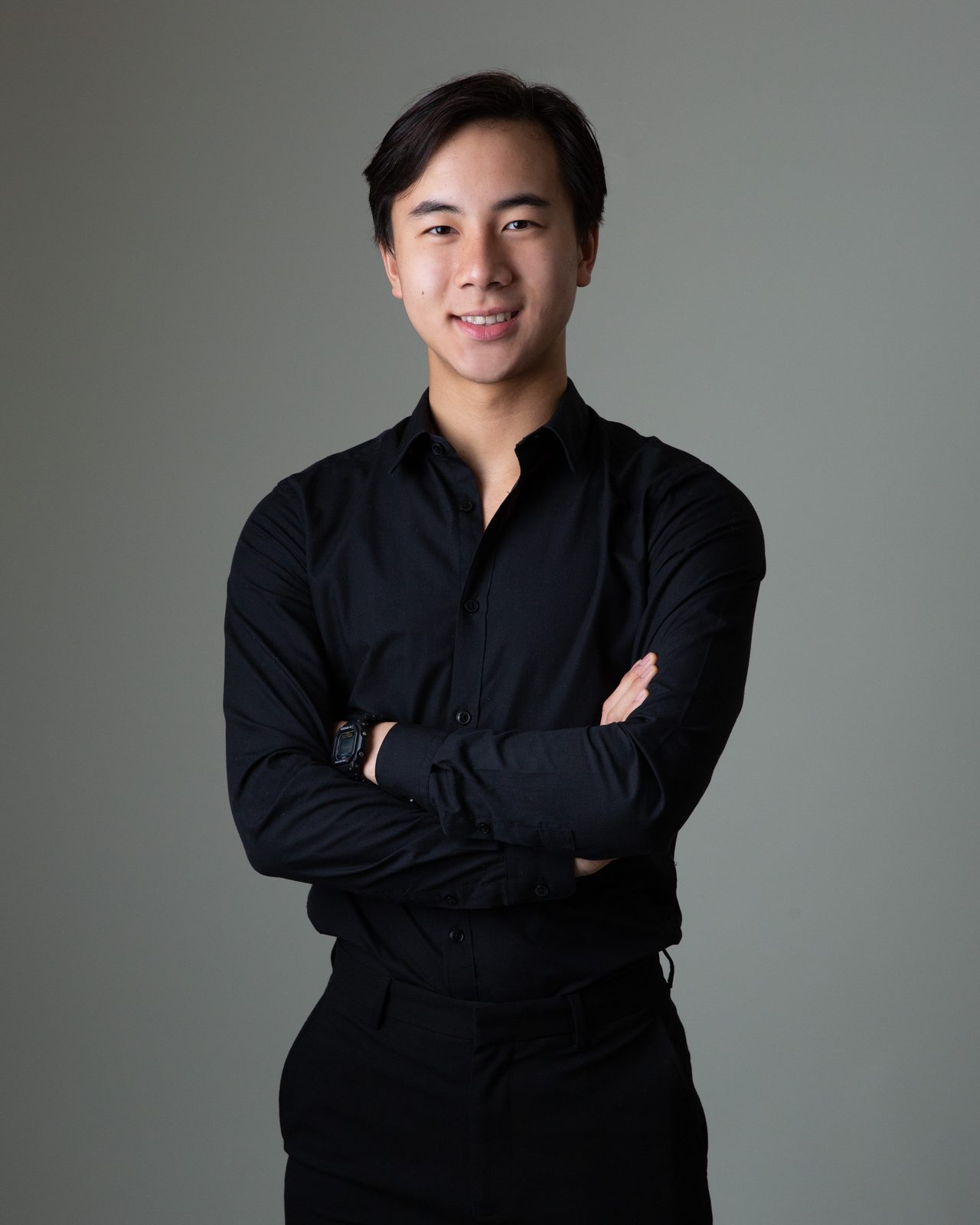 Will Cheah, arms folded, in front of a plain studio backdrop.